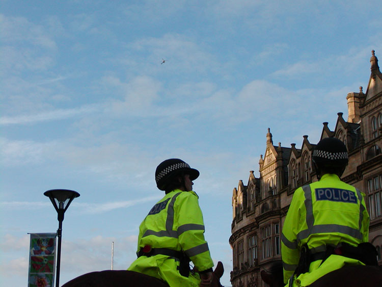 Mounted police with copter overhead