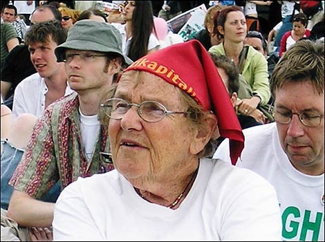 Older woman listens to speakers at the Stop the War Coalition / CND stage