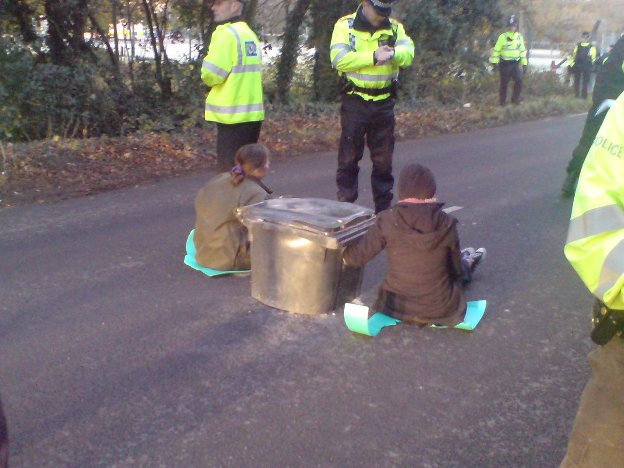 Sitting in the road with a bin