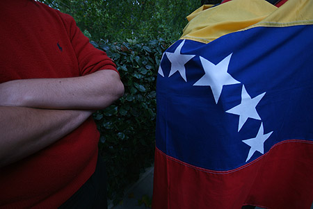 Venezuelan flag and folded arms.