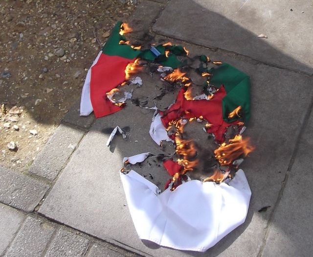 A Bulgarian flag being burnt outside the Embassy