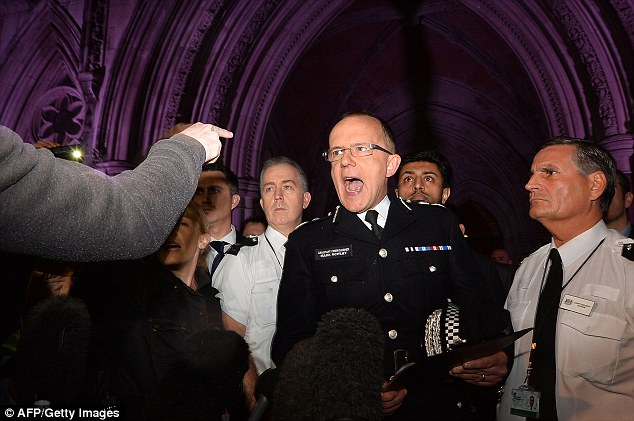 Assistant Commissioner Mark Rowley challenged by protesters outside the court
