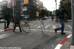 Activists using razor wire from the wall to block Basel Street in downtown Tel A