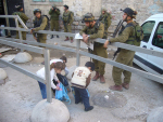 Israeli soldier searches children at checkpoint