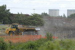 Clounds of dust kicked up by machinary on site, Clays Lane Estate in background