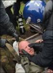 "A RIOT cop restrains a protester": The Sun (1)