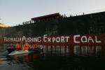 Greenpeace activists paint "Australia Pushing Export Coal"