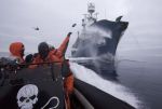 Boat crew deploy butyric acid on a harpoon ship. Photo: Adam Lau/Sea Shepherd