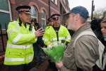 A marcher argues with police about their behaviour on April 1