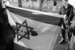 Demonstrators holding up a blood-stained Israeli flag (photo: Lisa Goldman)