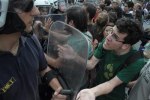 A young protester tries to reason with cops as Greeks strike yet again