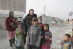 Maya Evans with children in a refugee camp