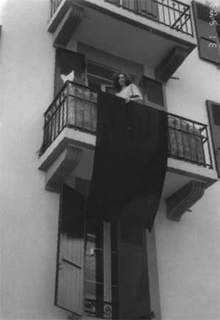 A house with a blackflag hanging from the balcony