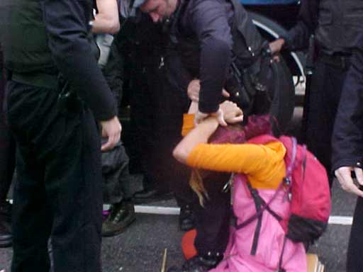 making arrests and pushing peole along the road