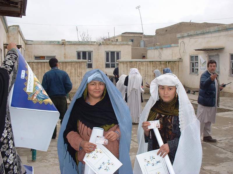 Two women, posters, registration cards