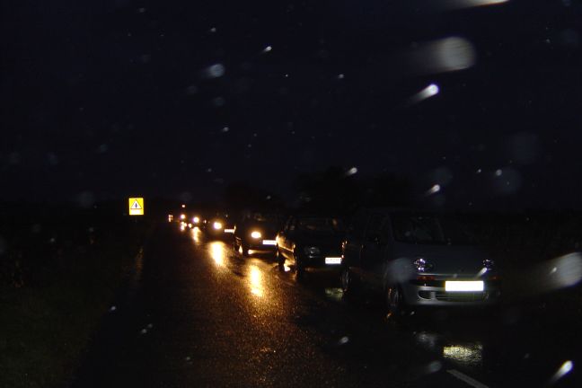 Cars of workers waiting to get in (cause the gates shut)