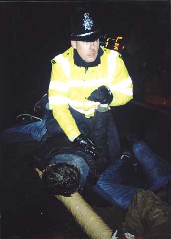 Our wonderful British bobbies torture a helpless locked on protestor.