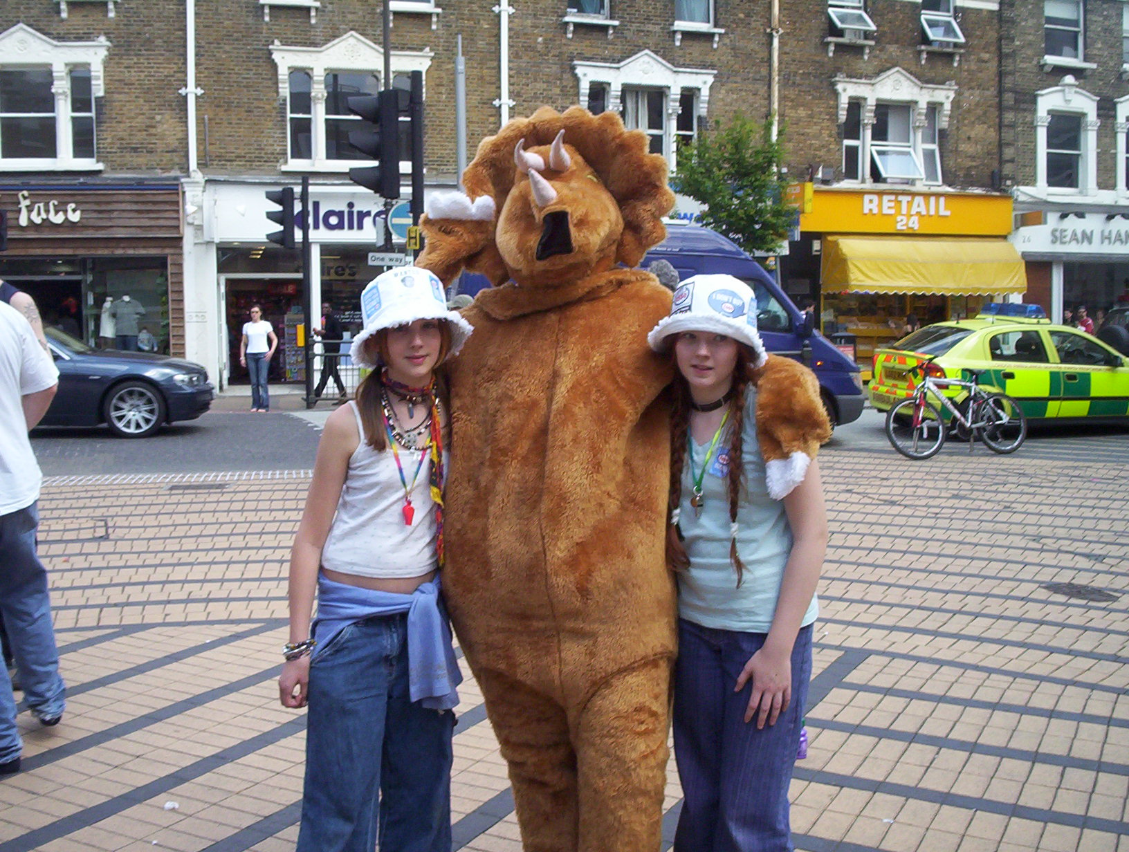 the triceratops poses with some young activists