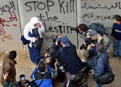 Palestinian woman poses for photographs
