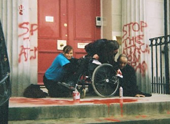 Anti-war slogans being painted outside the US Consulate in Regent Terrace.