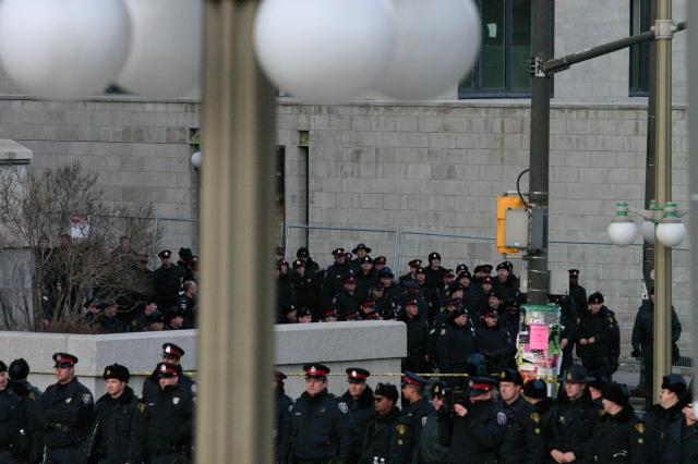 Police watch crowds gathered outside US Embassy