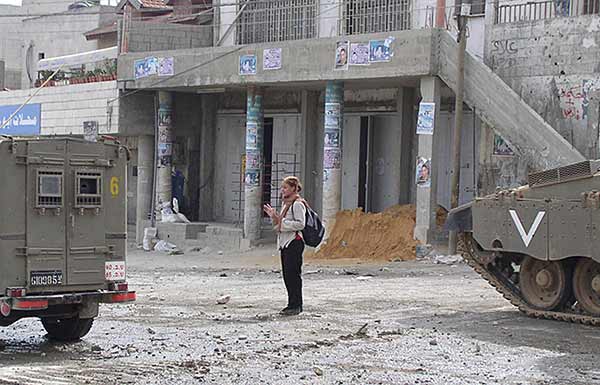 Kelly, blocking a jeep from firing into the camp.