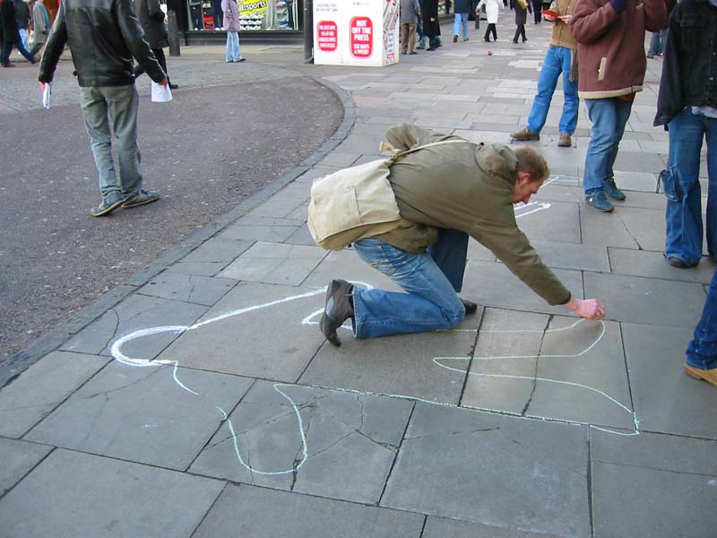 ...drew body outlines on the pavement to represent...