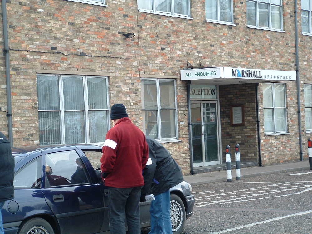 pickets stop cars as they go in to work