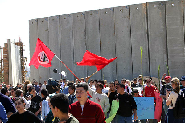 Palestinians and internationals marching through the gap in the Wall, Bethlehem