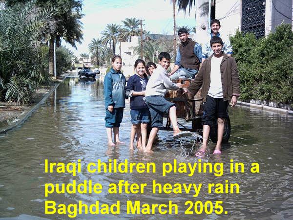 Baghdad children playing in puddle after rain. March 2005.