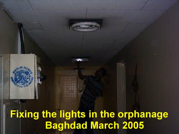 Replacing damaged light fittings. Baghdad March 2005.