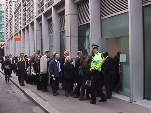 Meanwhile, security lockdown forces staff to queue for entry via fire exit.