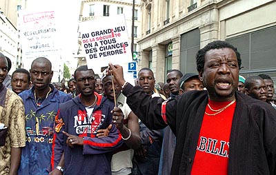 Citizens of France's former colonys demonstrate against borders.