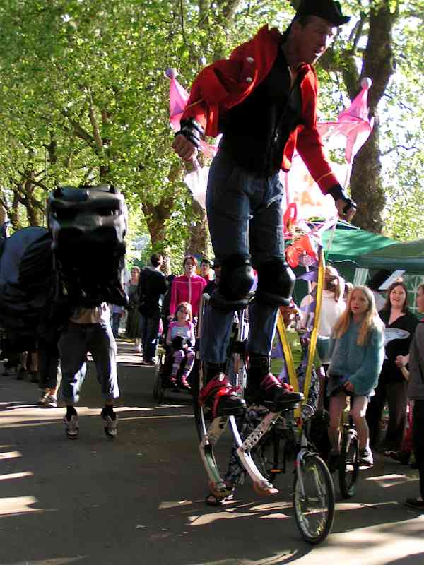 Procession D - hi-tech stilt walker aloft