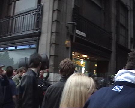 People dumping a bin on the riot police