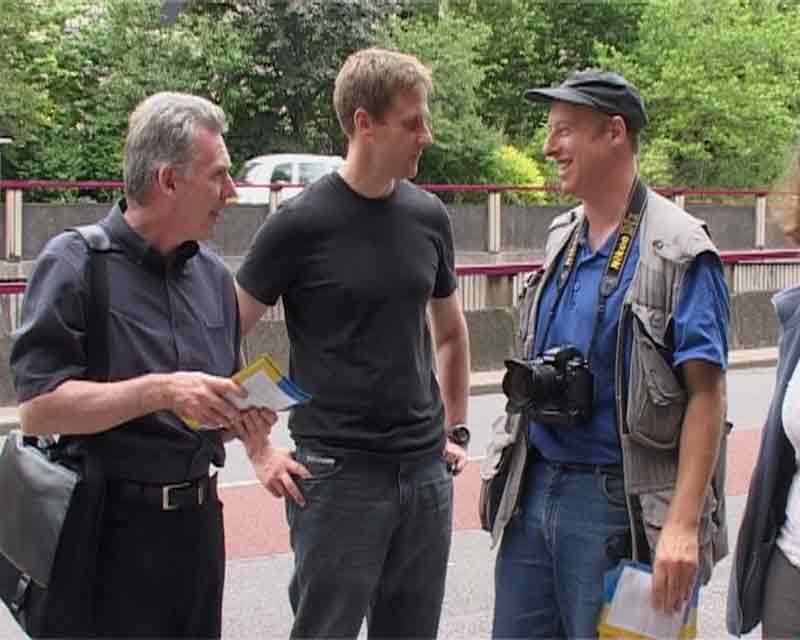 Videostill: three journalists at the action
