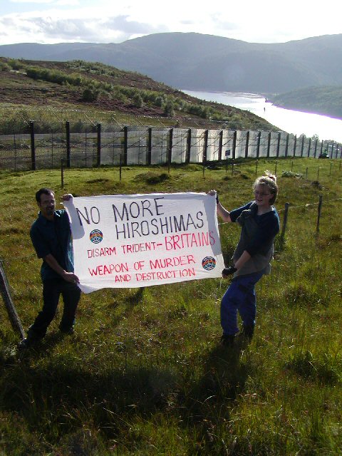 Protestors held banners while being escorted by MOD police with dogs and quads
