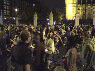 Dancing in the street with sound system outside Houses of Parliament.