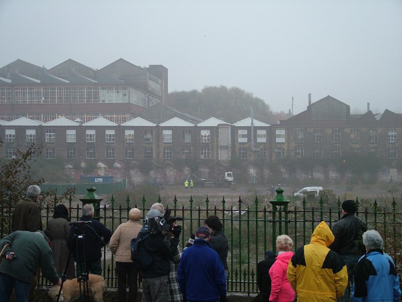 Campaigners and TV crews monitor asbestos factory rubble removal...