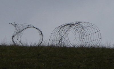 Fencing cut down and left on site
