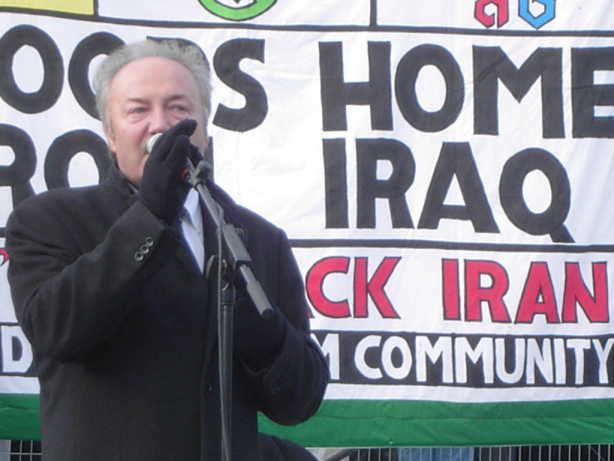 George Galloway on stage with Iraq banner