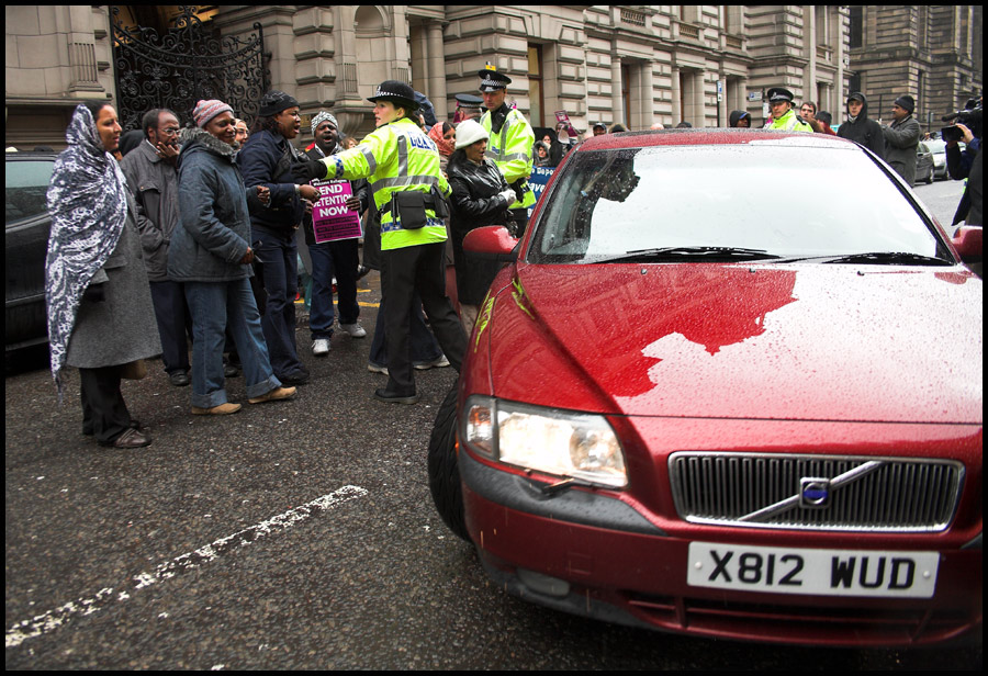 Immigration Minister 'Numpty' McNulty cowers on back seat of limo