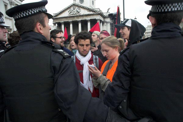 Legal Observer takes notes as police stop marchers