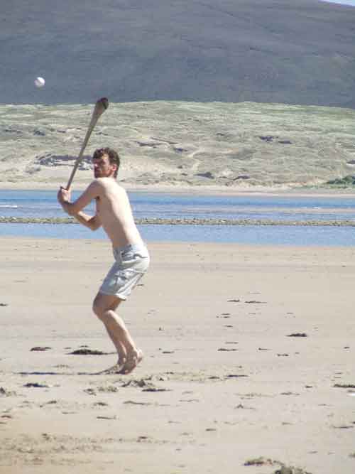 Playing hurley on the beach