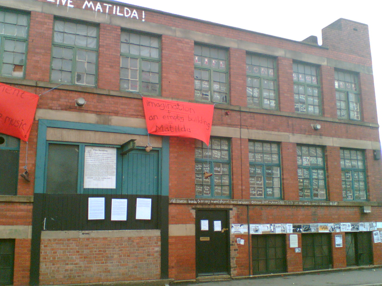 Outside of MATILDA. The windows are painted with the names of every band that pl