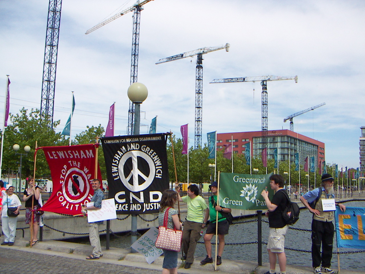Cranes on ExCeL land with protestors