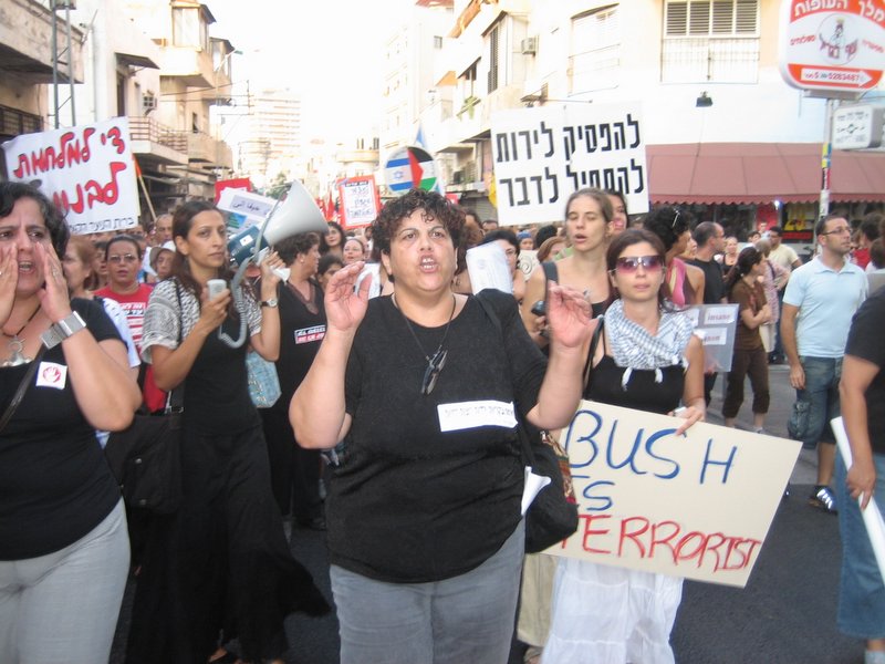 Women march at the head. "Stop shooting, start talking!"