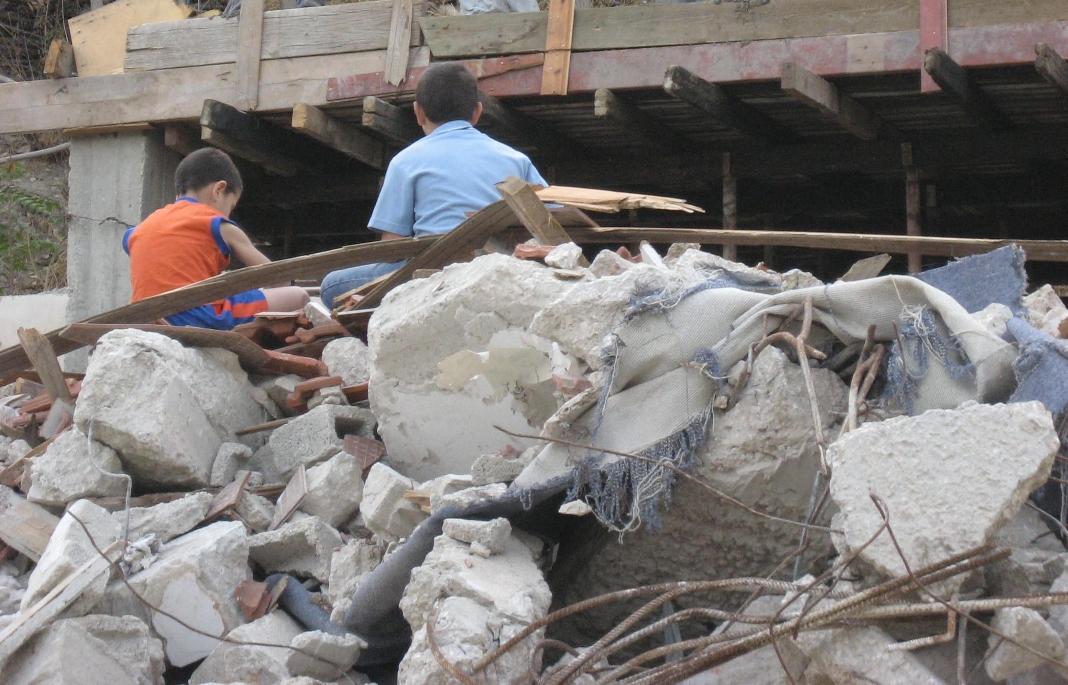 Hani's sons on rubble of former home