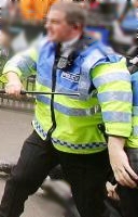 an unarmed policeman bravely faces protesters wanting violence (archive image)