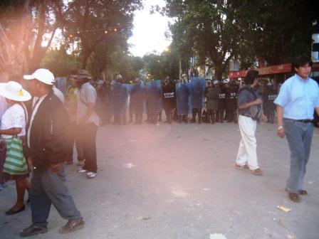 Line of police defending the rich mob